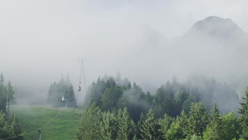 Gondolas going up to a mountain top