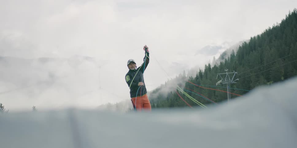 A man sets up the lines of a parachute