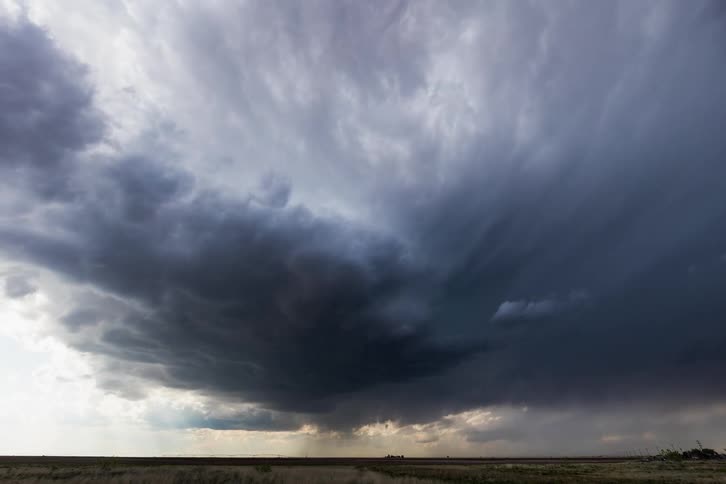 Storm clouds moving over a flat plain