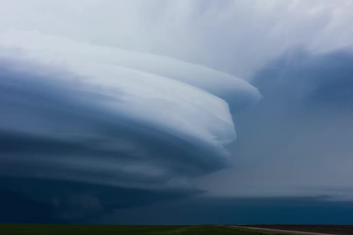 Powerful lightning storm sweeping across a country field in slow motion