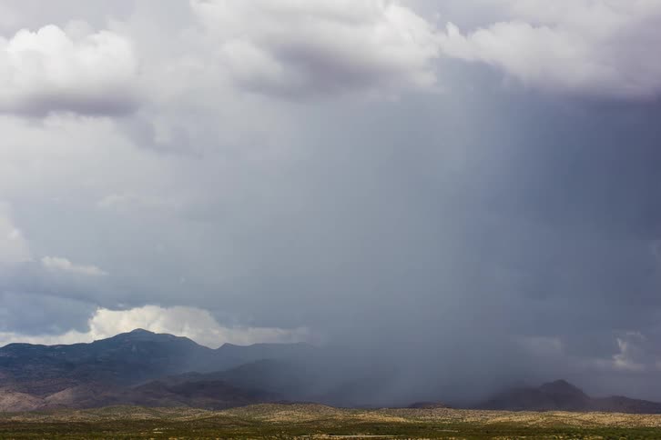 A cloud front moving through a field