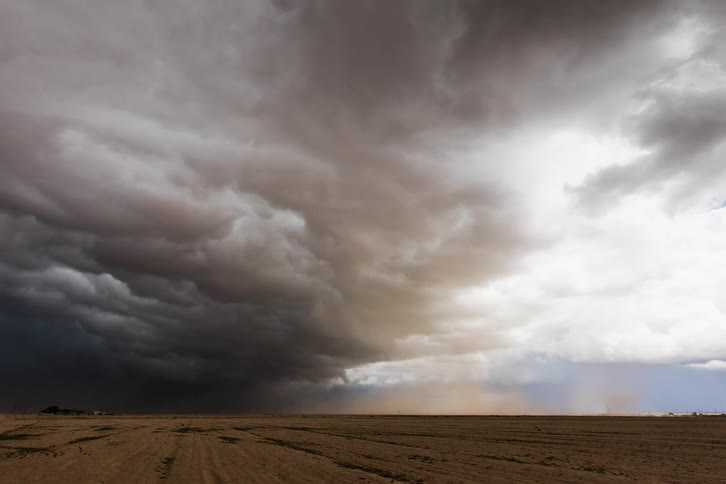 Dark stormy clouds gather over the dry plains