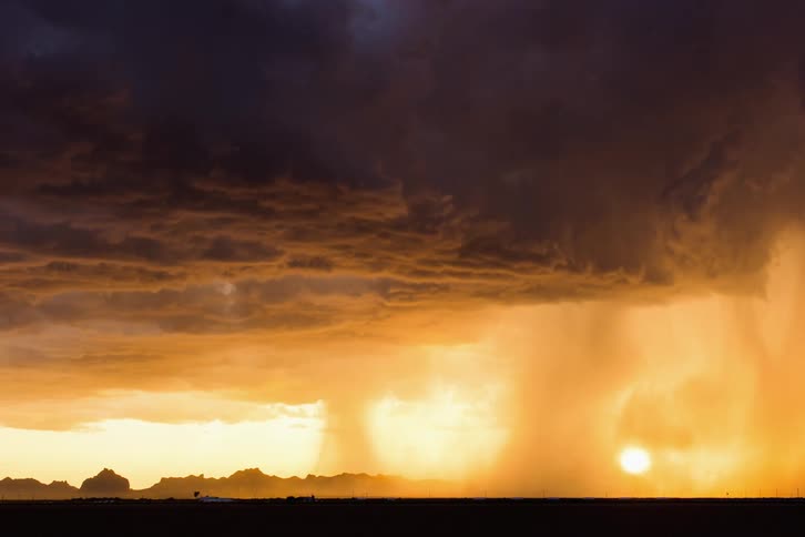 A cloud front moving across a field