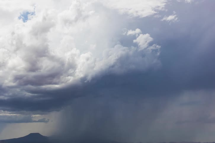 Thick clouds moving above a mountain