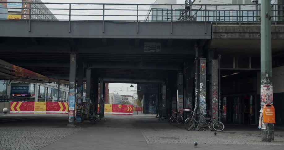 The city street is empty with birds flying around