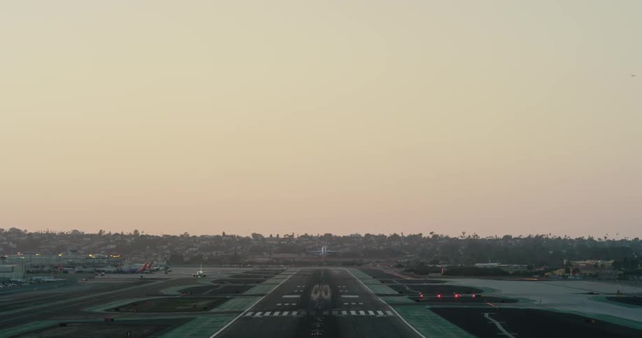 A jet rolling down the runway and flying into the sky