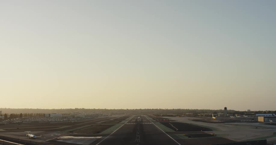 Horizon glows slightly as airplane lands on landing strip