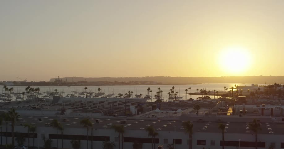 The sun rises off the coast of the town