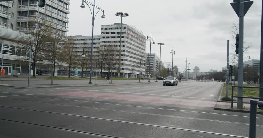 A lone car drives down empty street in a downtown area