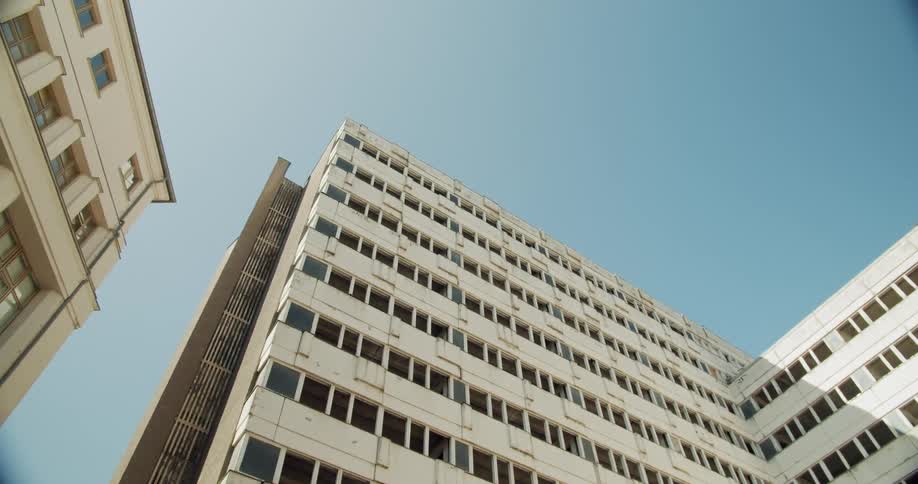 Buildings in apartment block on city at day