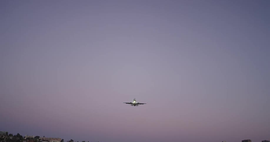 An airplane flies over a city