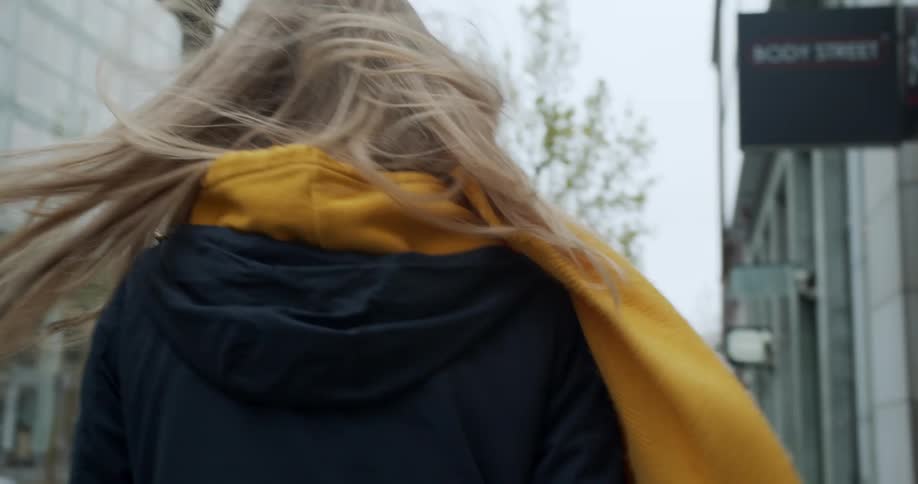 A woman wears a face mask in a city