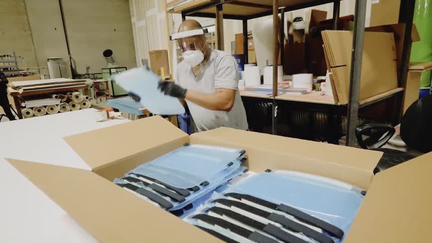 A man is packing items in a box