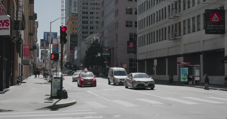 Cars stopping before a red light at an intersection