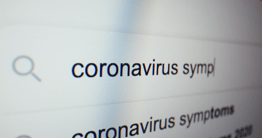 Someone uses a computer to search for coronavirus symptoms