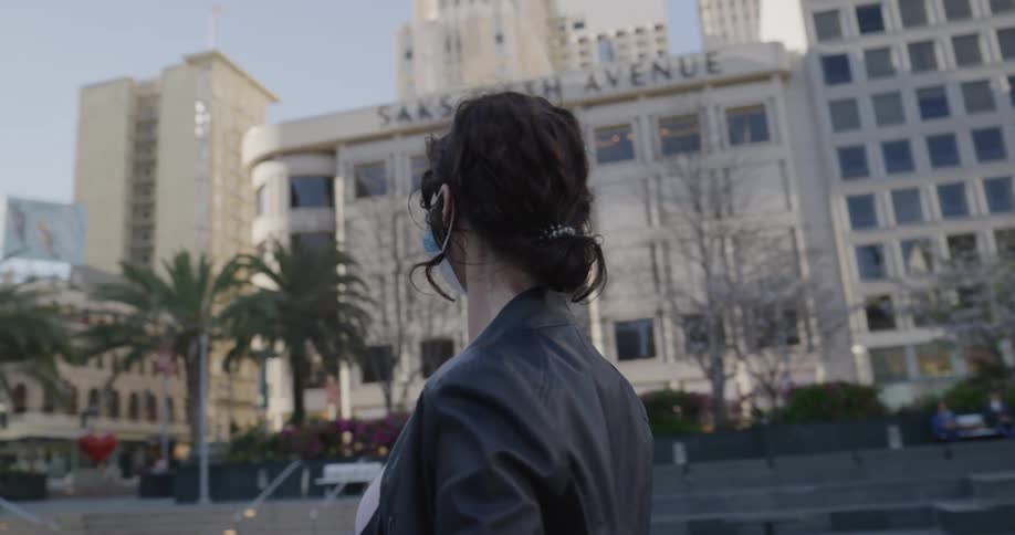 A woman looks around the empty city
