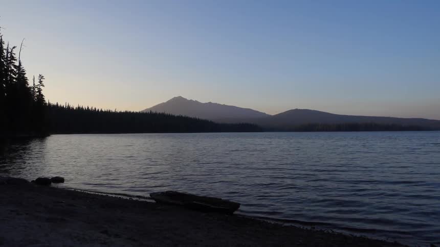 Lake waters lapping the shoreline at dusk or dawn