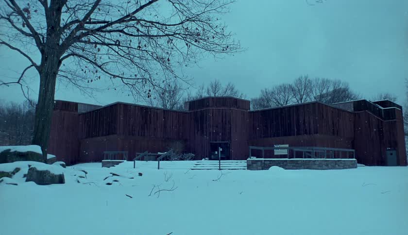 Snow covers a building and landscape