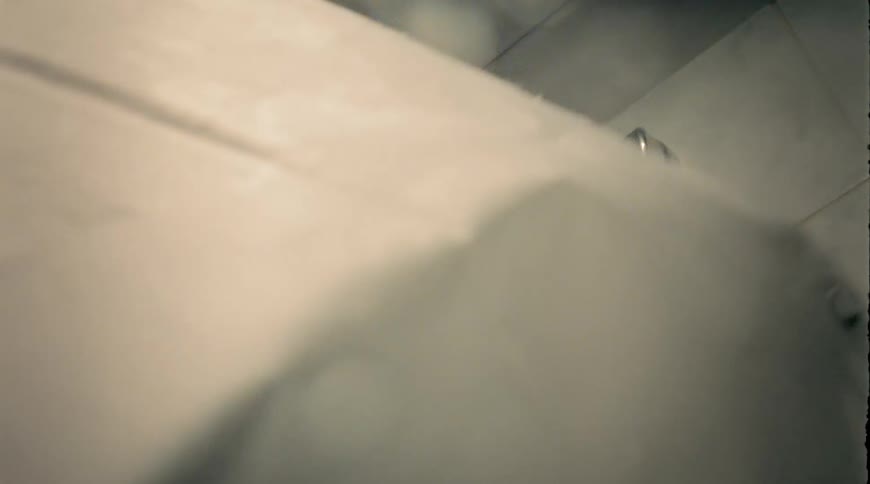 A shower curtain being ripped off the hooks