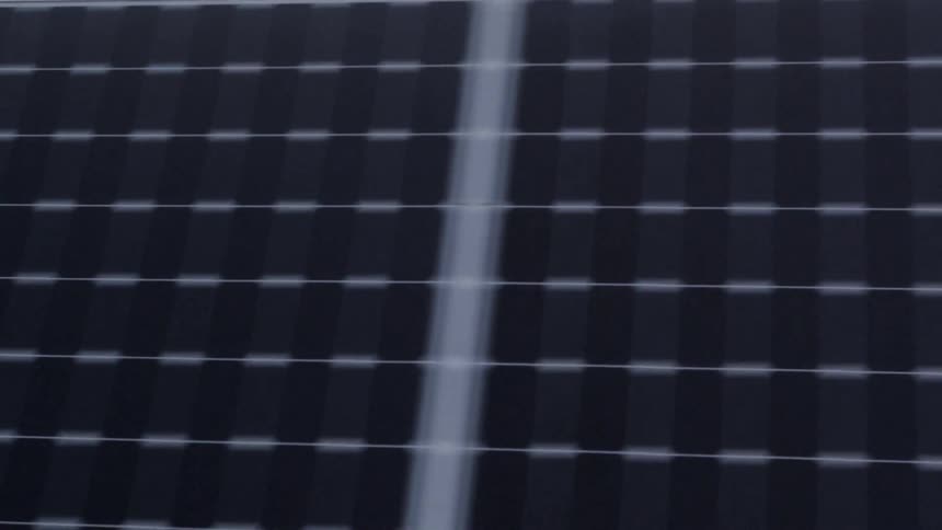 Extreme closeup traverse passing over cells of solar panels
