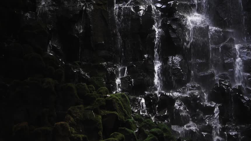 Water trickles down a cliff wall