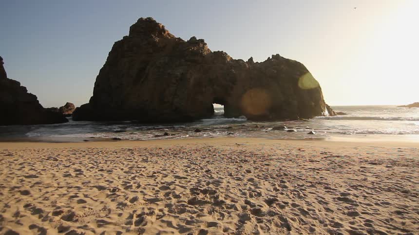 Ocean waves wash ashore a sandy beach