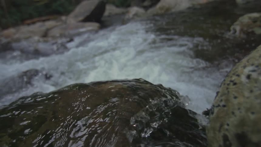 Water flows down a rocky river