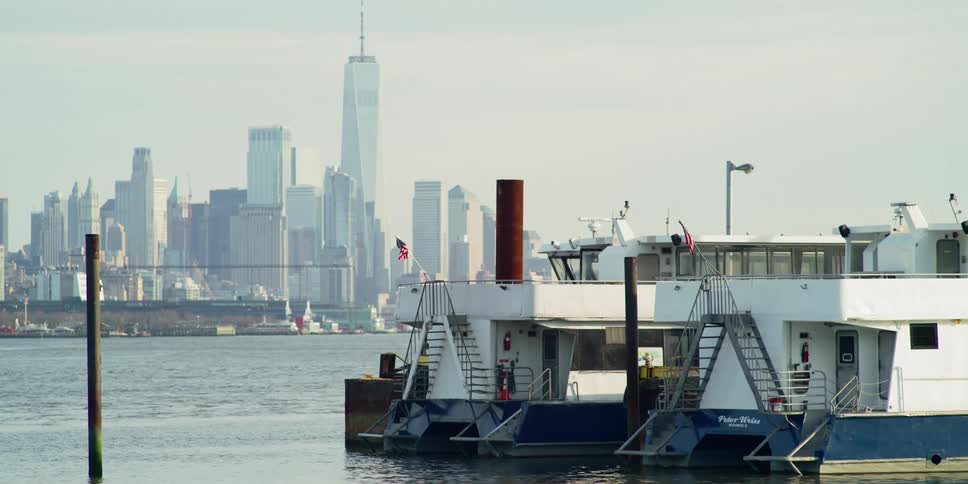 Boats on the water with the city skyline in the distance