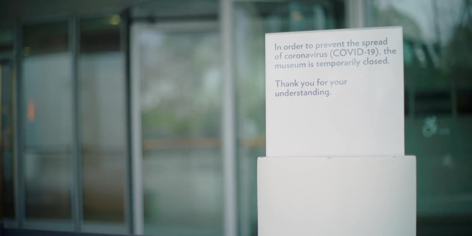 A closed sign hangs on a museum window