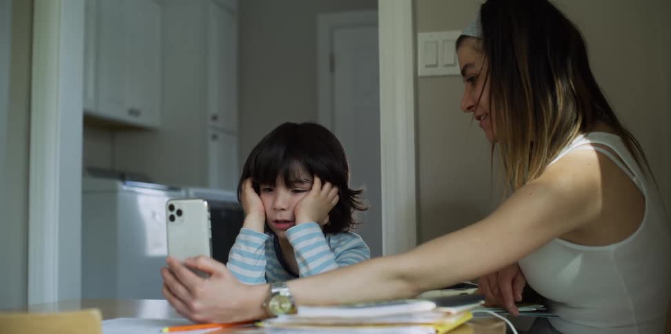 A boy and girl talk on the phone