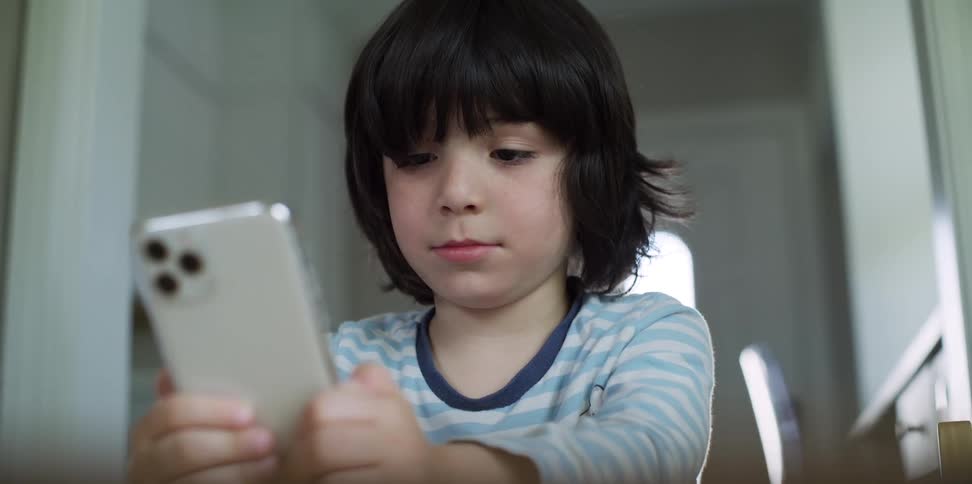 A boy holding a smart phone