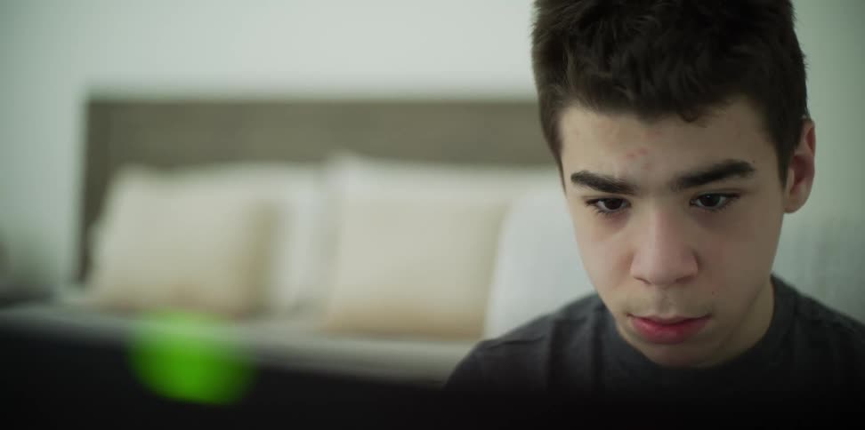 A teenager working on a computer