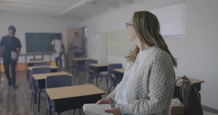 Reading instructor greets students as they enter the classroom