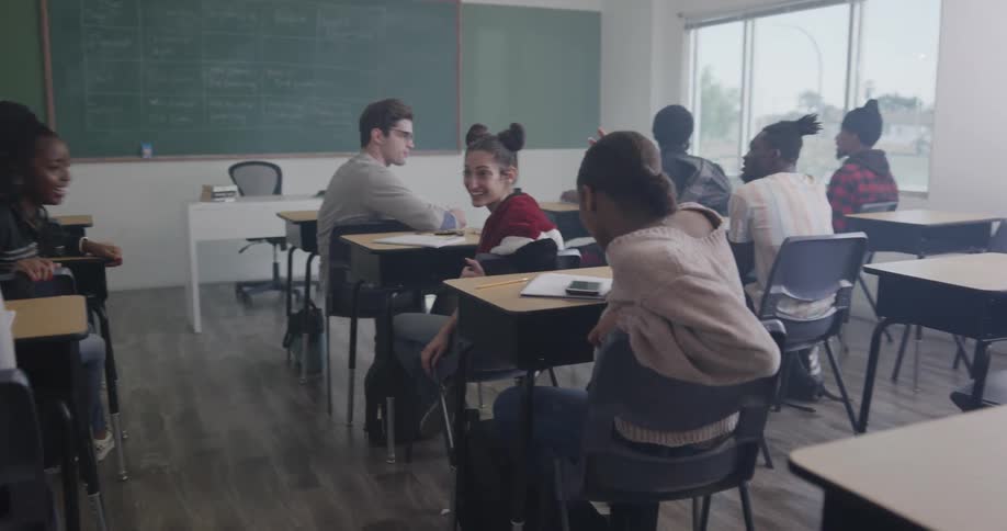 Students sitting in a classroom talking