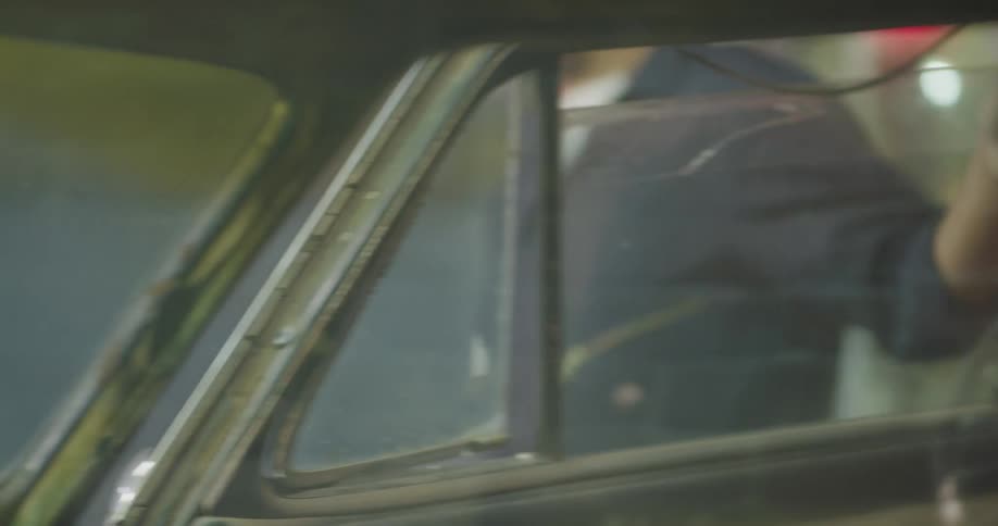 Man working on car in warehouse