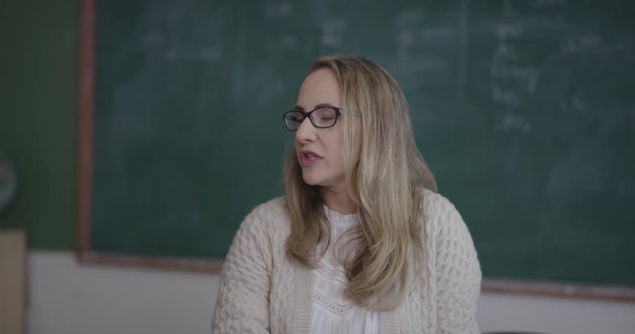 A teacher is giving a lecture in a classroom