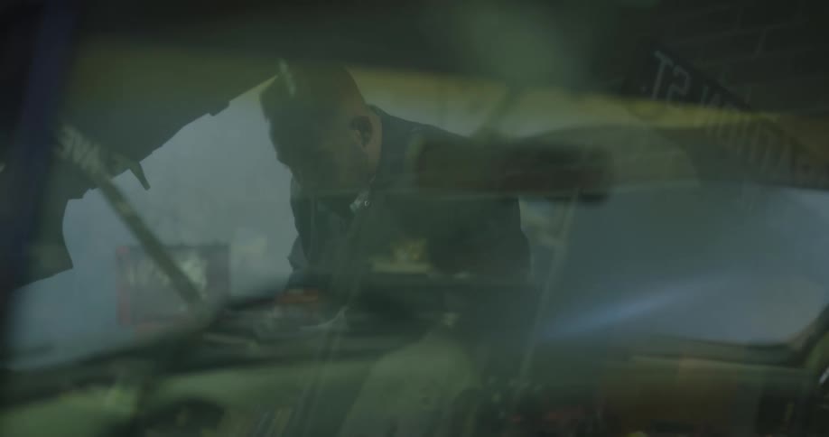 A mechanic works on a car