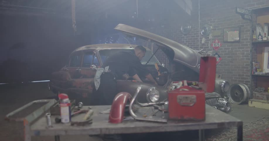 A mechanic works on a car