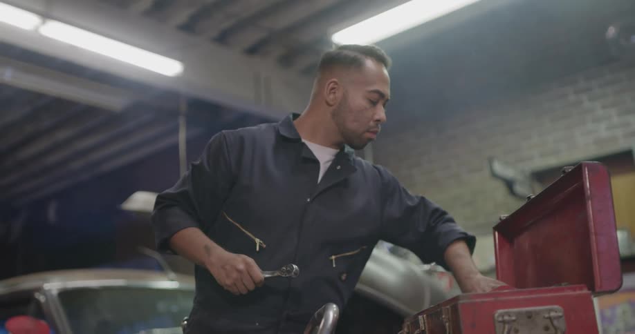 A mechanic grabbing a socket wrench to work on his car