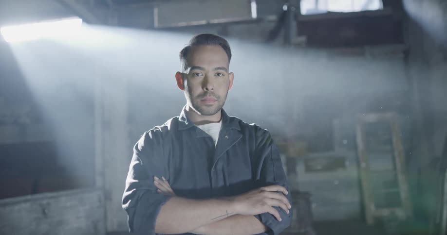 A man stands with his arms folded