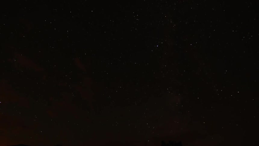 The stars in the night sky moving slightly