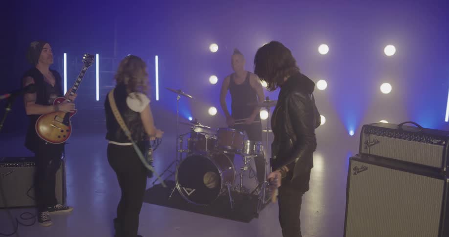 The band walks toward their instruments