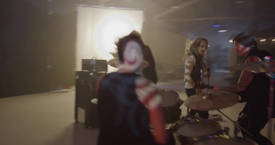 A band plays their instruments on stage