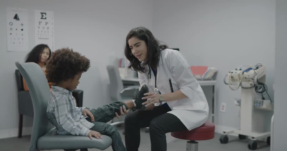 A doctor checking a childs leg