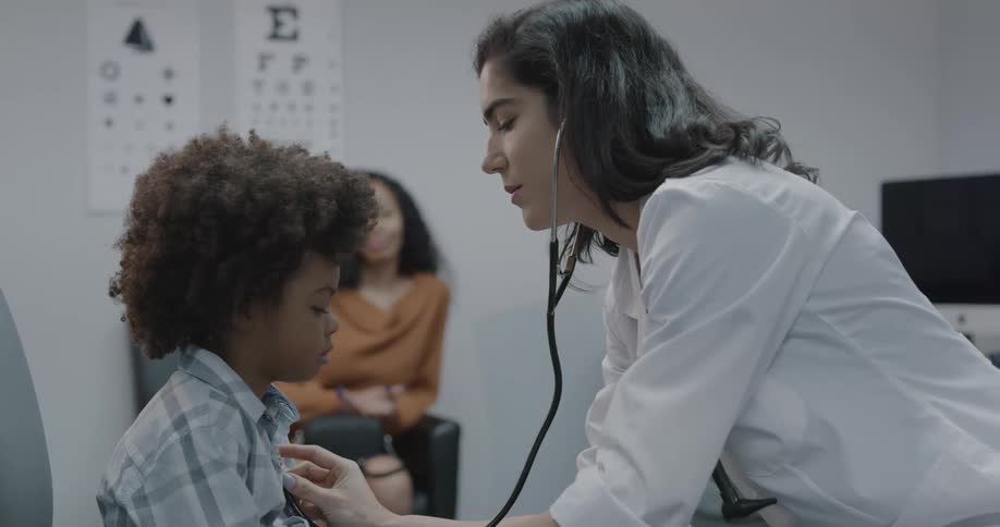 A doctor checking a childs pulse