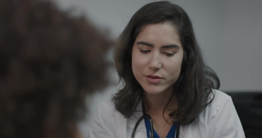Doctor references tablet as she explain childs diagnosis