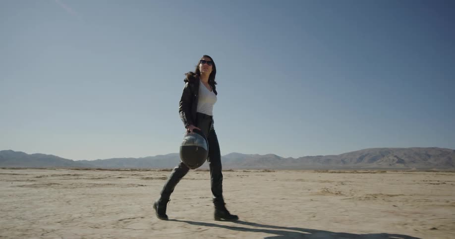 A woman walks in the desert