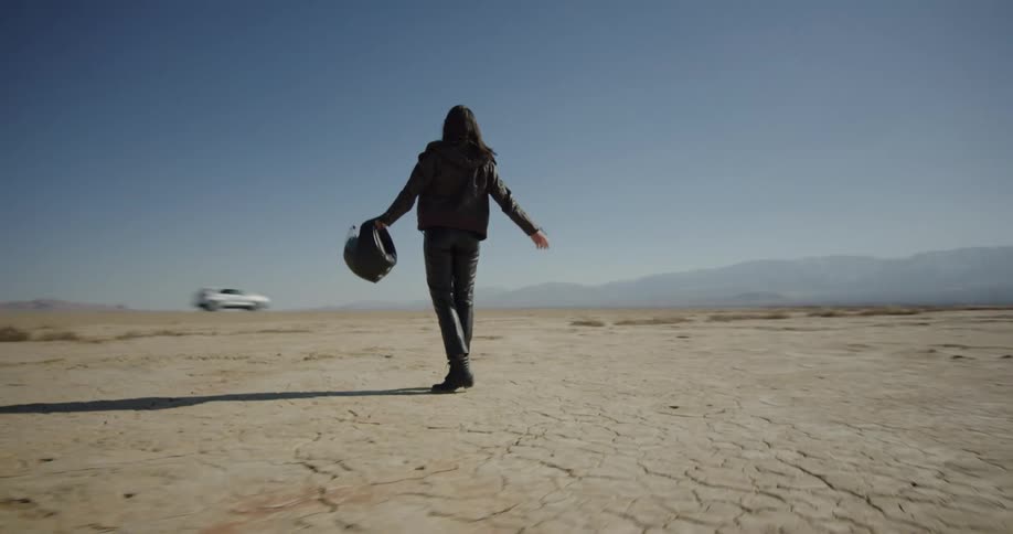 A woman spins in the desert