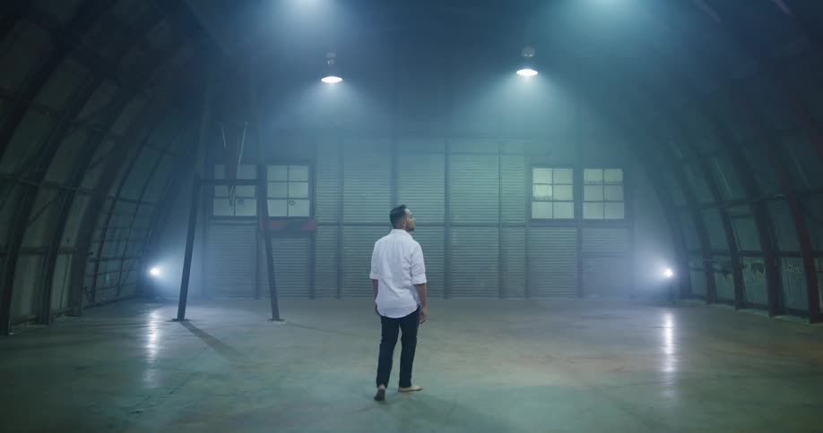 A man walking into an empty room