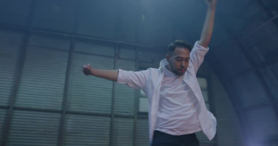 A man dances across a stage